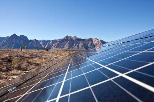 An image of solar panels in a desert