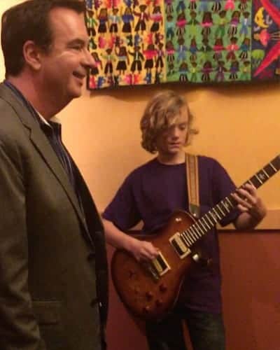 Mark Glen Moore giving a brand new Paul Reed Smith guitar signed by Journey to Jackson Young
